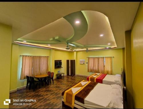 a hotel room with a bed and a table at ICONIC Hotel Digha in Digha