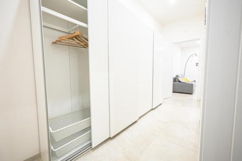 a hallway with white cabinets and a walk in closet at Villa Lumia in Tre Fontane