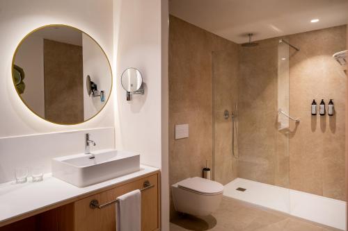 a bathroom with a sink toilet and a shower at Iberostar Waves Gaviotas Park in Morro del Jable