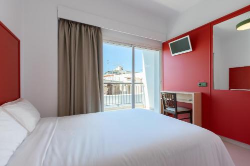 a bedroom with a white bed and a window at The Red Hotel - Adults Only in San Antonio