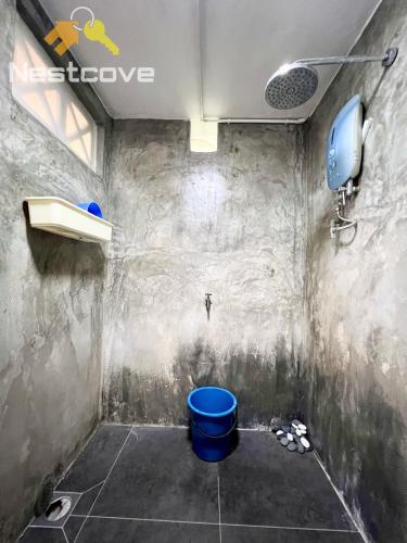 a bathroom with a blue toilet in a room at D Simple Haus By Nestcove in Melaka
