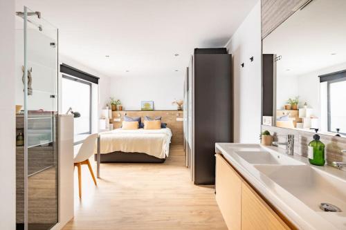 a bathroom with a bed and a sink in a room at Calle Mayor 21 VUT1222AS in Llanes