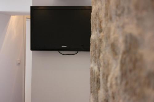 a flat screen tv sitting on top of a wall at Medulić Palace Rooms & Apartments 2 in Šibenik