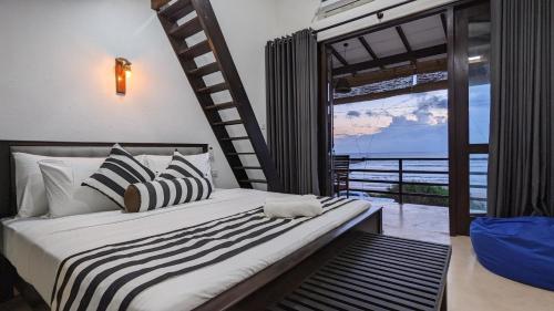 a bedroom with a bed with a view of the ocean at Surf edge villa in Mawella