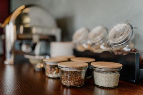 a group of four jars sitting on a wooden table at Altes Gutshaus Klink in Klink