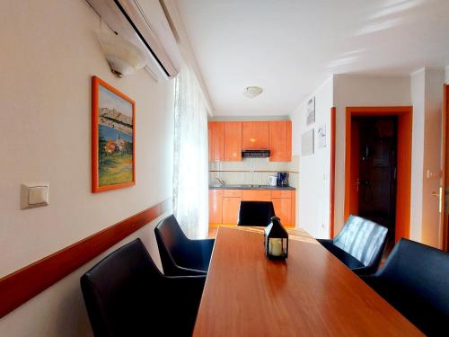 a dining room with a wooden table and chairs at Villa Ana in Baška