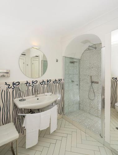 a bathroom with a sink and a shower at Hotel Le Agavi in Positano