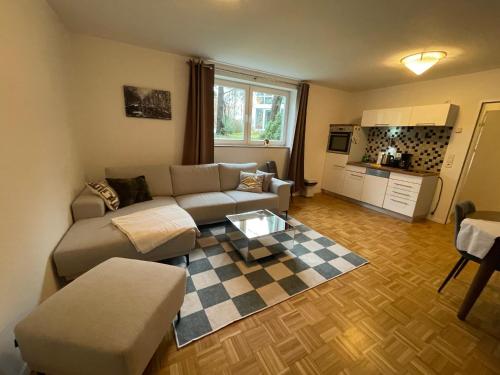 a living room with a couch and a table at Ferienwohnungen Krügerstraße in Dresden