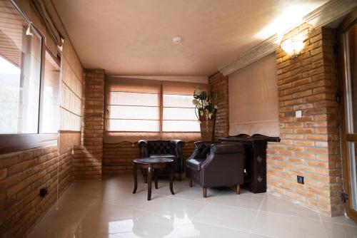 a room with a table and chairs and a brick wall at Solva Resort Medical & SPA in Polyana