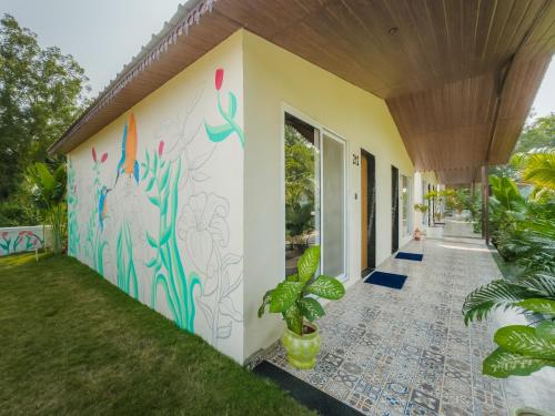 a wall mural on the side of a house at RiverView Tent Resort in Kevadia
