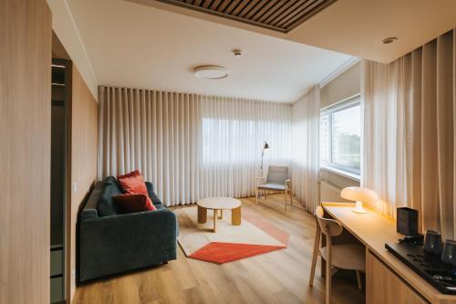 a living room with a couch and a table at Hestia Hotel Strand in Pärnu