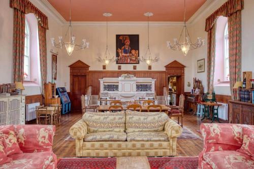 a living room with a couch and a table at Historic Chapel Great Facilities nr Beaches in Saint Ewe