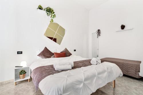 a bedroom with a large bed with white walls at Grace House Navigli in Milan