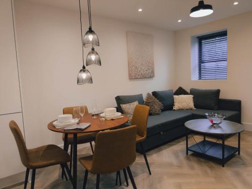 a living room with a couch and a table at Luxurious Apartment in St Albans in St. Albans
