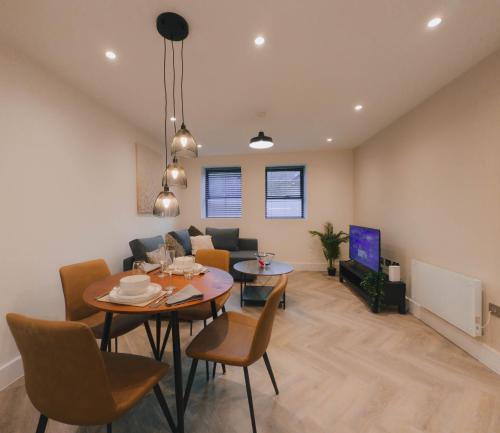 a living room with a table and a couch at Luxurious Apartment in St Albans in St. Albans