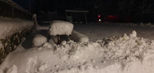 a pile of snow on a fence in a yard at Lipno & Wellness Chata in Loučovice