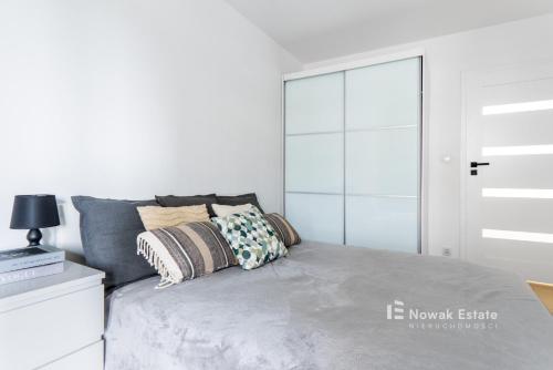 a bedroom with a bed with a glass door at Promienistych 2 in Kraków