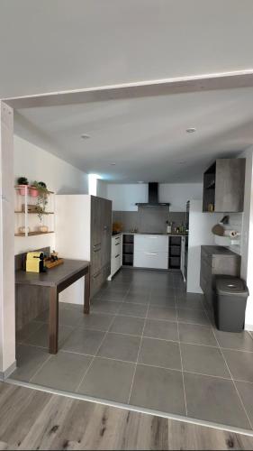 a large kitchen with a table in the middle at Gîte duplex les Glycines in Bennwihr
