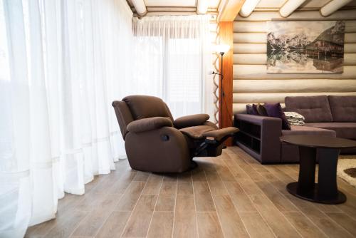 a living room with a chair and a couch at Solva Resort Medical & SPA in Polyana