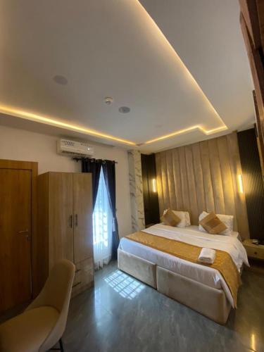 a bedroom with a large bed and a window at Lighthouse Inn and suites in Ibadan