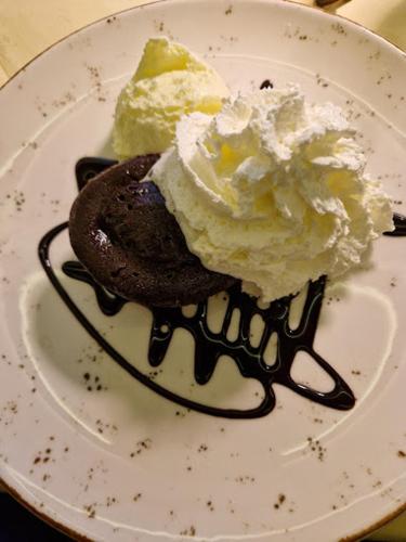 a plate with ice cream and a chocolate dessert at Hegyi Panzió in Szilvásvárad
