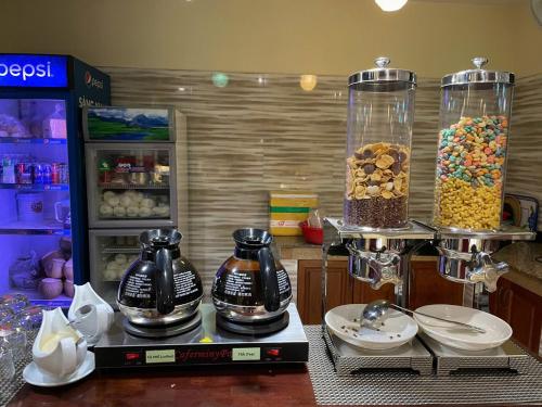 a counter with two large containers of cereal and drinks at THANH TAI HOTEl 1 in Ho Chi Minh City