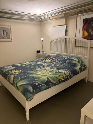 a bedroom with a bed with a blanket on it at Souterrain aan zee in Noordwijk