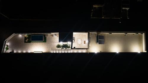 a house lit up at night with lights at Villa Lumia in Tre Fontane