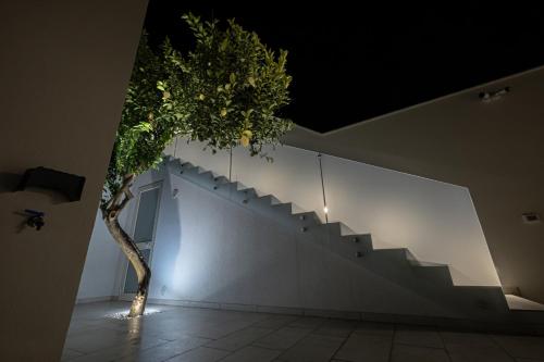 a tree in a room with a staircase at Villa Lumia in Tre Fontane
