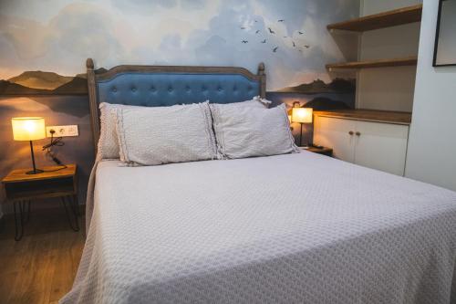 Ένα ή περισσότερα κρεβάτια σε δωμάτιο στο Apartamentos Nueva Ribera