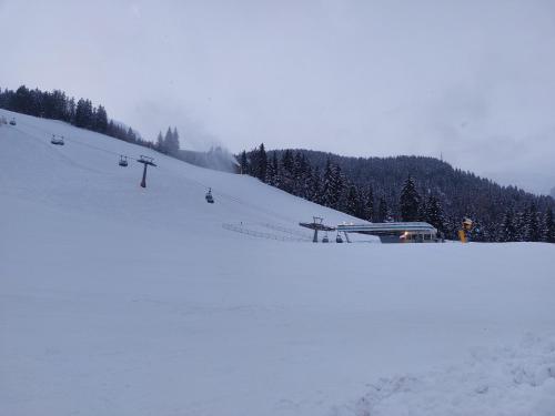 a snow covered ski slope with a ski lift at Blosegghof Bergchalets Himmelblick in Racines