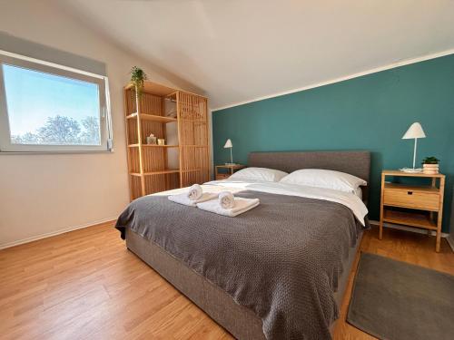 a bedroom with a large bed and a window at Sveti Duh Apartment Seaview in Posedarje