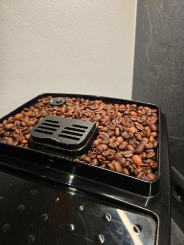 a pan of coffee beans with a remote control on it at Blosegghof Bergchalets Apt Almwiese in Racines