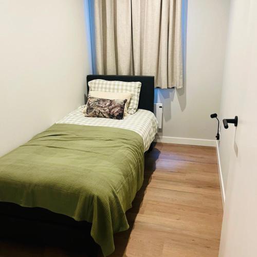 a small bedroom with a bed with a pillow on it at Tante Ursula B&B in Venlo