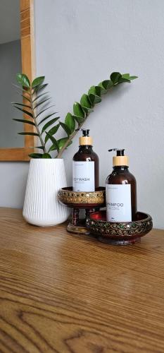 two bottles of soap sitting on top of a table at Velanon Phuket in Ban Lo Long