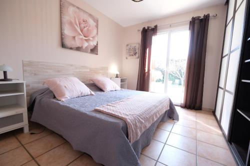 une chambre avec un lit et une grande fenêtre dans l'établissement Provençal house, pool, Mouriès, Alpilles, Provence - 6 people, à Mouriès