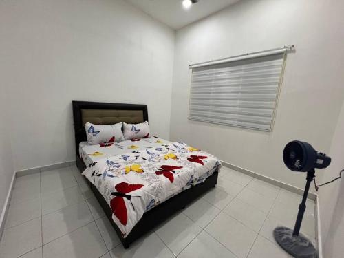 a bedroom with a bed with a camera on a tripod at Rumah Cemara by Impian Homestay in Sepang