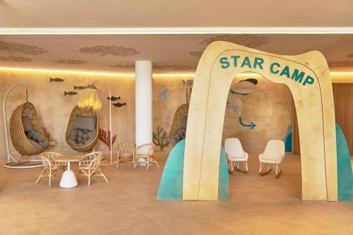 a star camp room with chairs and tables and a sign at Iberostar Waves Gaviotas Park in Morro del Jable