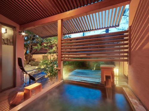 a house with a swimming pool with a deck at Hokuriku Fukui Awara Onsen Mimatsu in Awara