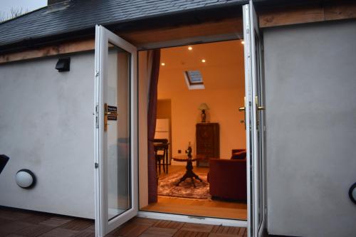 an open sliding glass door of a house at Tobervilla Guest House in Caherdaniel