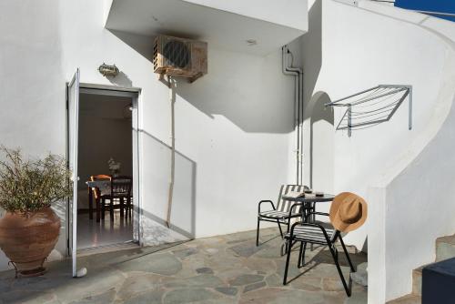 a room with a table and chairs and a staircase at Merichas 7 Irida in Mérikhas