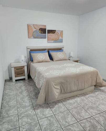 a bedroom with a bed and a tiled floor at Fantastic Holiday Apartment in Arona