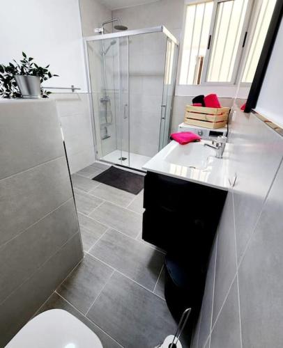 a bathroom with a toilet and a shower and a sink at Fantastic Holiday Apartment in Arona