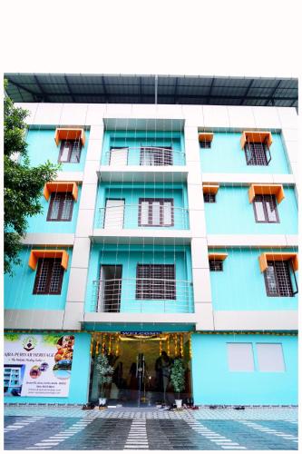 a blue and white building with orange balconies at Vajra Periyar Heritage in Alwaye