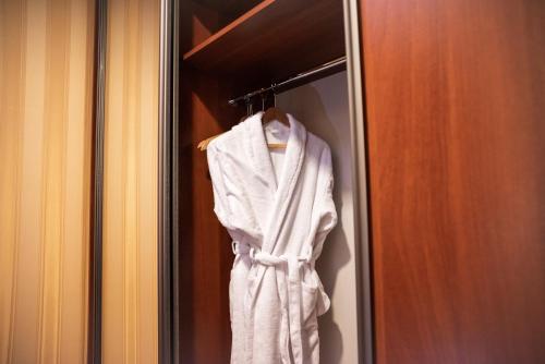 a white robe hanging on a closet door at Solva Resort Medical & SPA in Polyana