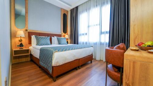 a hotel room with a bed and a chair at Grand Sirkeci Hotel in Istanbul