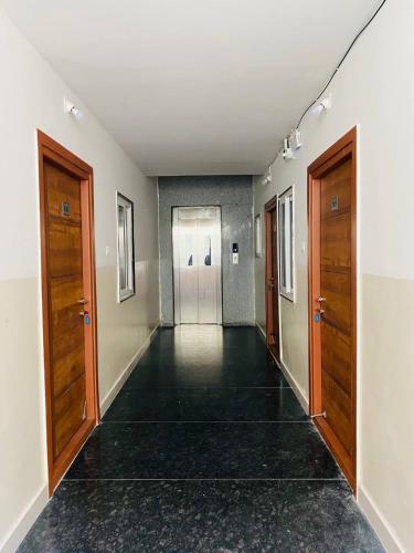 an empty hallway with two doors and a hallwayngth at HK Guest Rooms in Guntūr