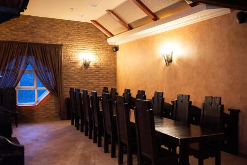 a dining room with a table and chairs and a window at Solva Resort Medical & SPA in Polyana