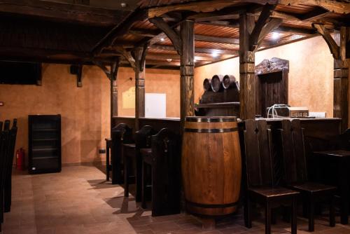 a bar with chairs and a wooden barrel at Solva Resort Medical & SPA in Polyana