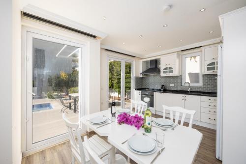 a kitchen and dining room with a white table and chairs at Residence Villa 1 in Oludeniz